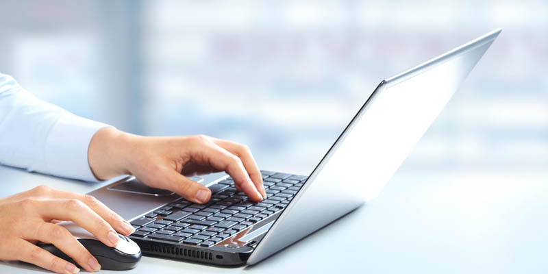 A woman searching on a laptop.