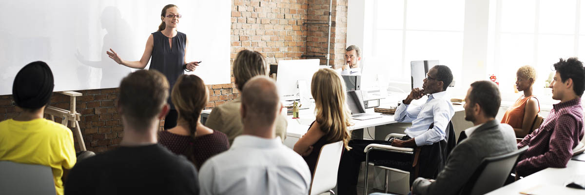Una persona dirigiéndose a un grupo en una oficina.
